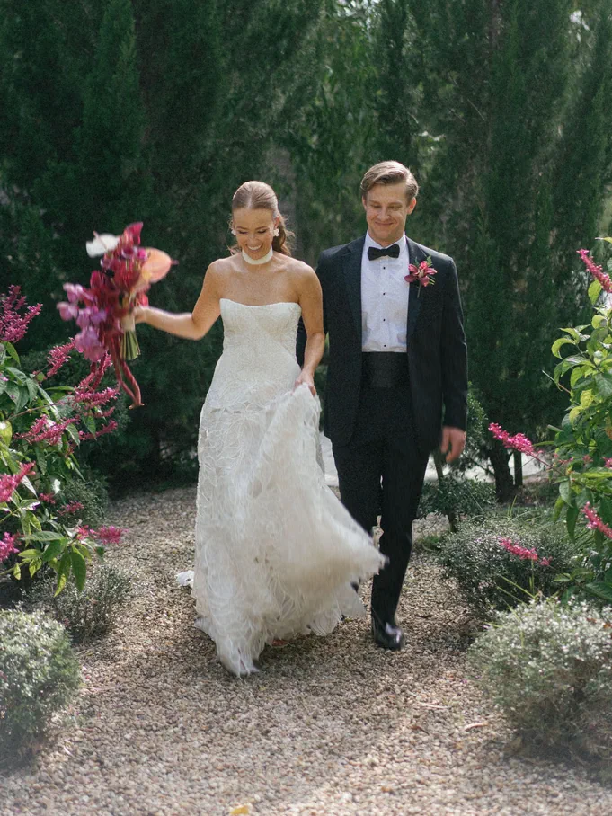 Newlyweds walking together at golden hour